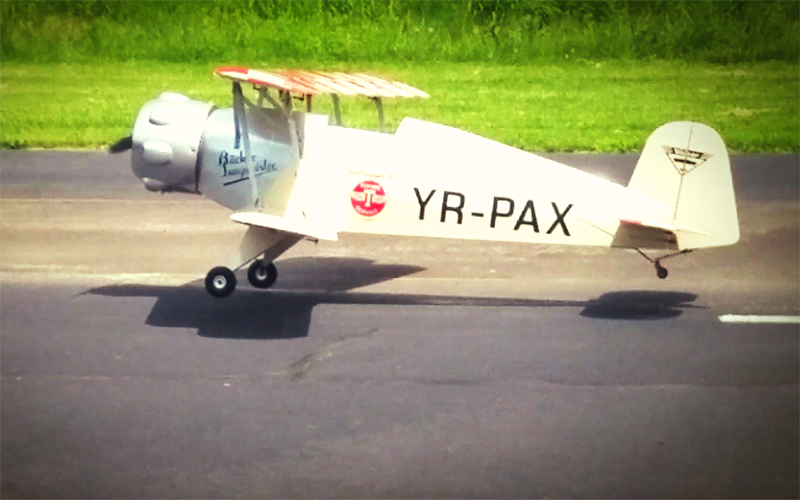 side view of 100" Bucker Bu-133 Jungmeister on a runway ready to take off